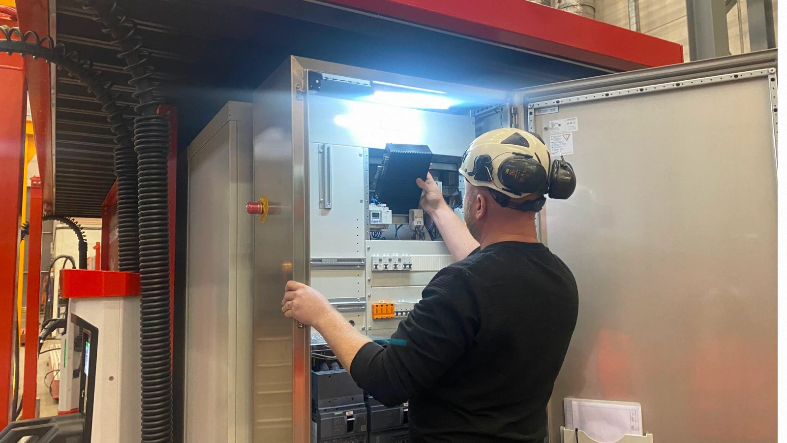 A tech replacing a component on a mobile battery unit supported by Pratexo software