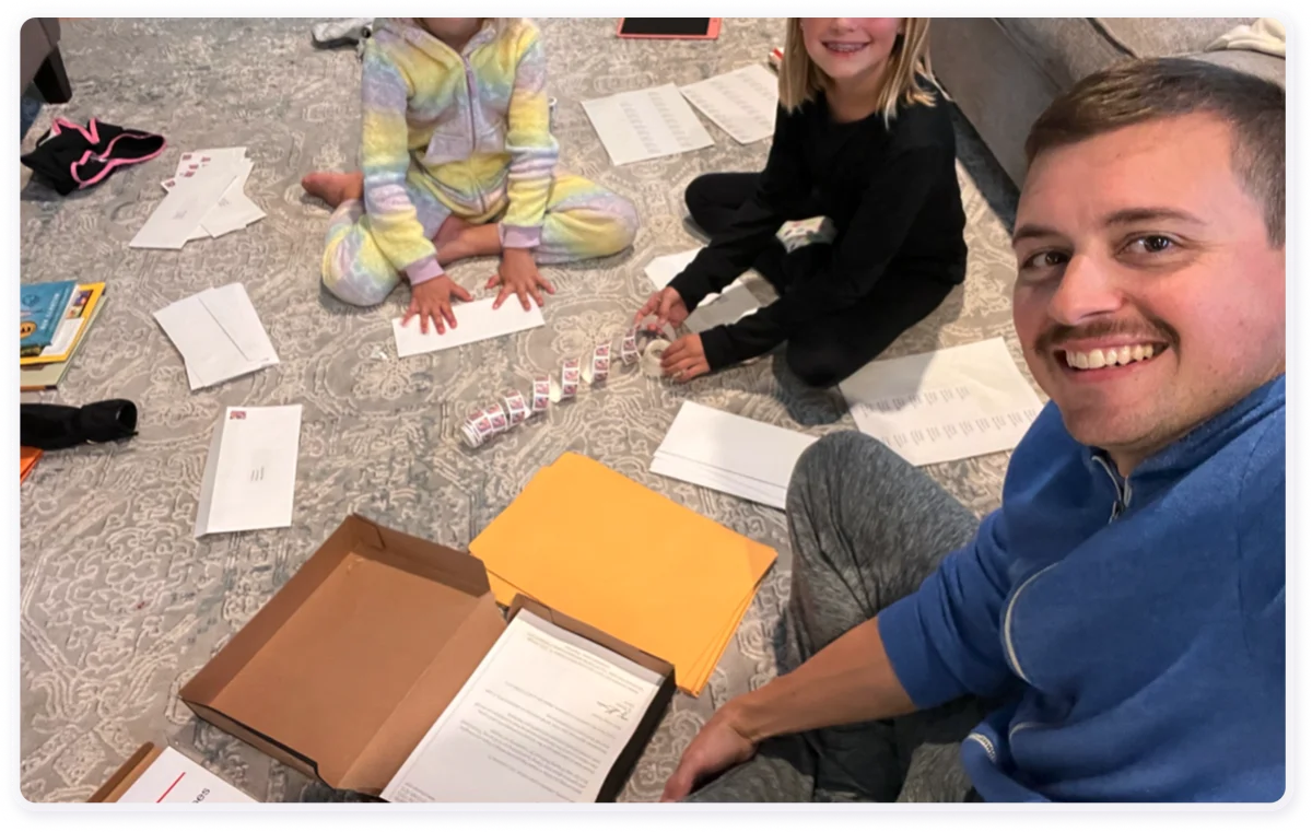 Chris stuffing envelopes to meet a deadline